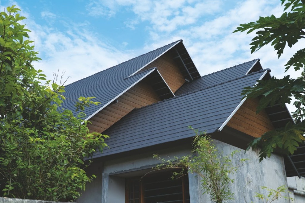 Contemporary home with layered clay tile roofing by Roofopolis
