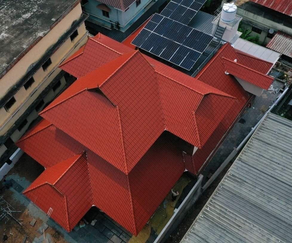 Aerial view of red clay tile roof villa by Roofopolis