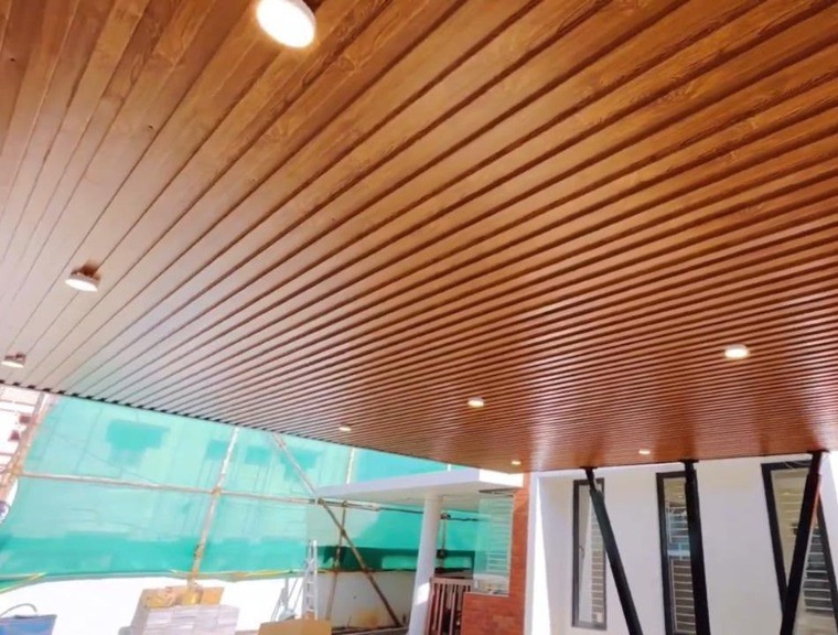Sleek wood-paneled carport ceiling by Roofopolis