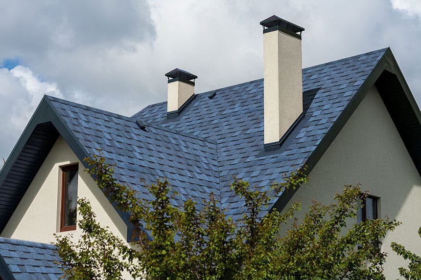Luxury home with slate blue asphalt shingles by Roofopolis