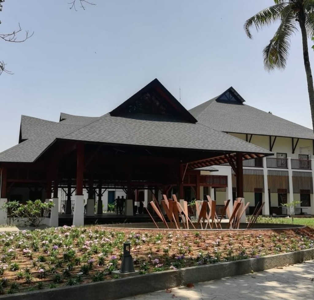 Large resort style building with high-pitch shingle roof by Roofopolis