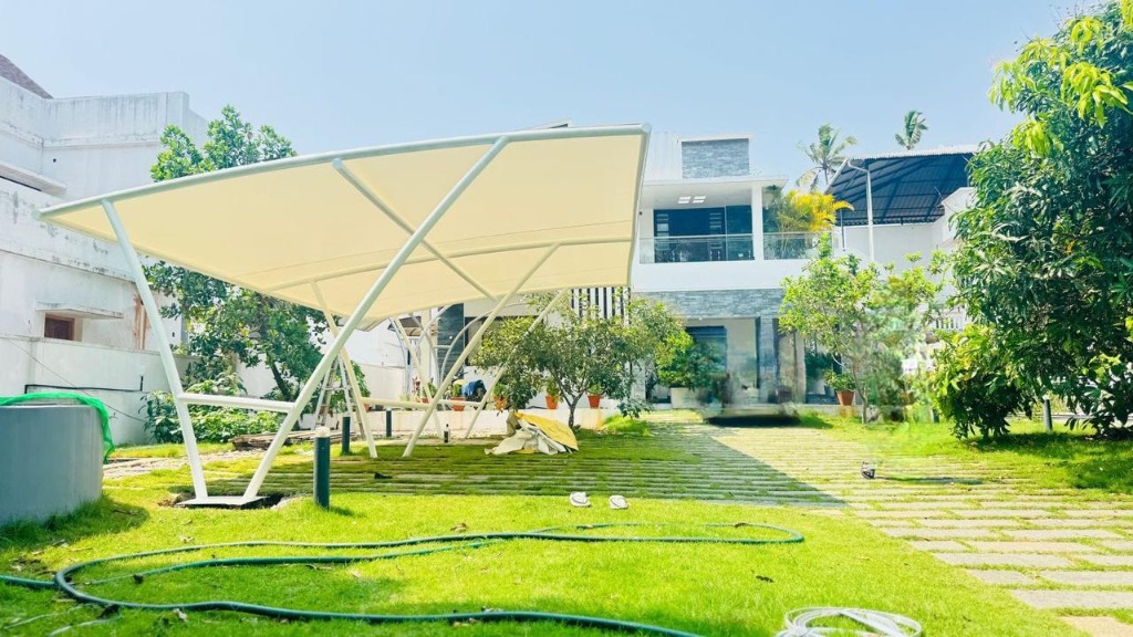 Curved tensile canopy over driveway